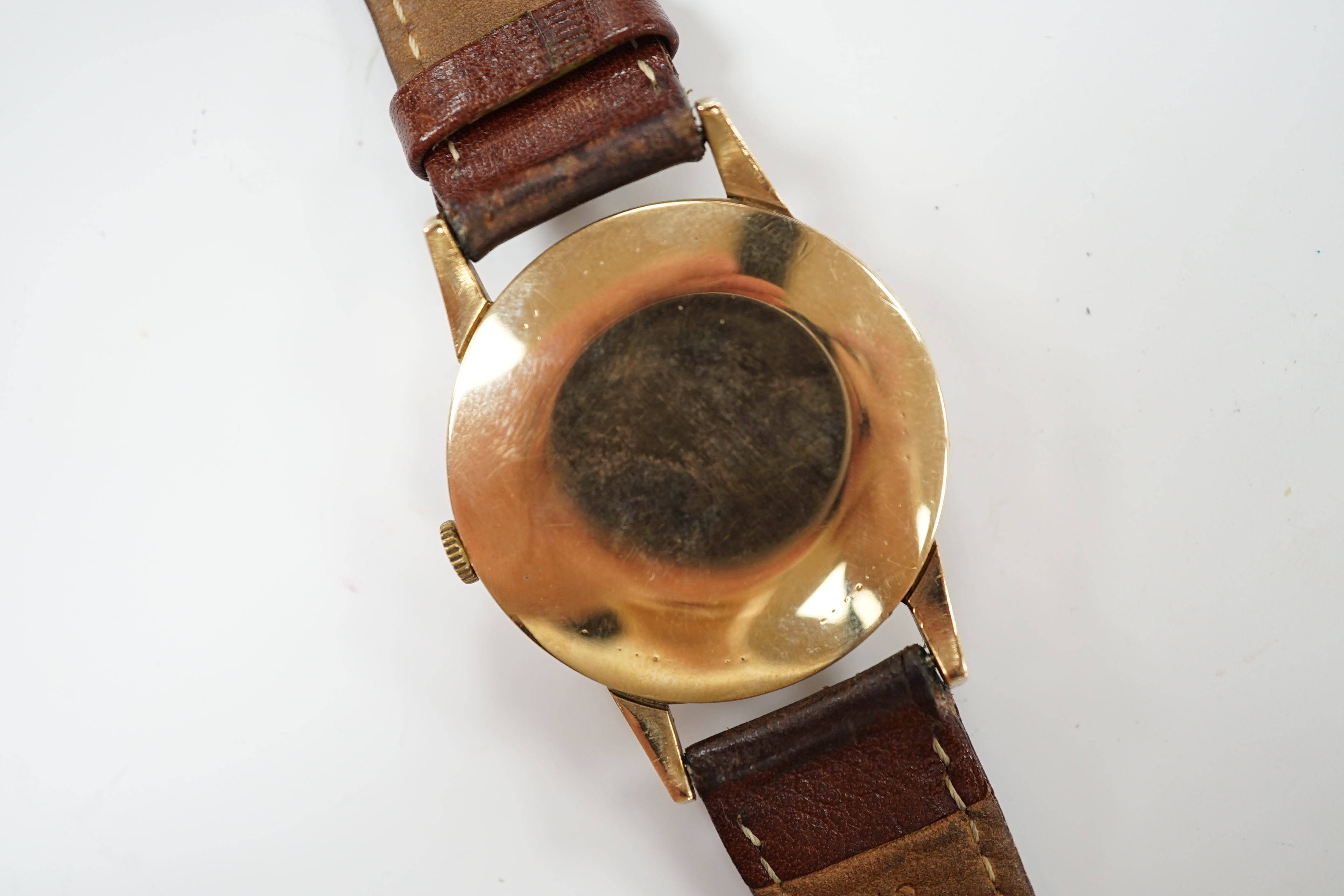 A gentleman's 1960's 9ct gold Tudor manual wind wrist watch, with baton and Arabic numerals later associated leather strap, case diameter 34mm.